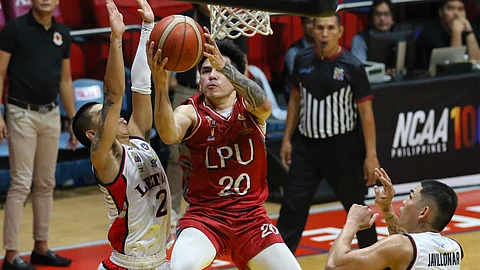 Renz Villegas of Lyceum penetrates the heart of Letran defense during their Season 100 NCAA men’s basketball tournament game on Friday. The Pirates won, 91-68.