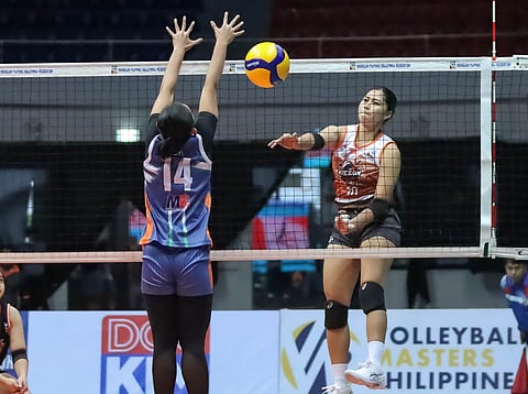 Mycah Go of the Quezon Tangerines connects an easy kill over the defense of Necelle Gual of AM Caloocan Air Force during their MPVA Season 1 game yesterday at the Quezon Convention Center.