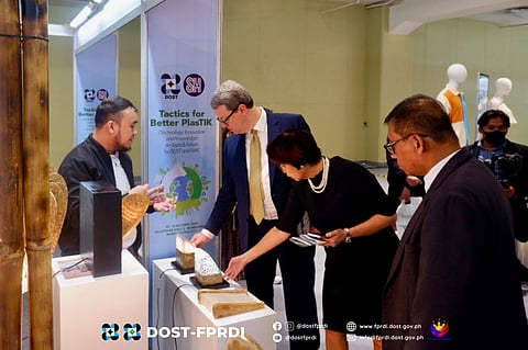 Engineer Liza Silerio, vice president for Corporate Compliance and head of Sustainability and Resilience at SM Cares of SM Supermalls (2nd from right), and Timothy Daniels, SM Investment Corporation head of sustainability and investor relations (2nd from left), check a recycled waste products exhibited at the Tactics for Better PlasTIK (Technology, Innovation and Knowledge) Expo and Forum at the SMX Megatrade Hall, Mandaluyong City.