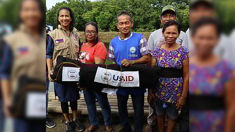 USAID Philippines Deputy Mission Director Rebekah Eubanks (left) with recipients of fishing nets during the handover of the gears at the Pasuquin Fish Farm in Ilocos Norte on 10 October.