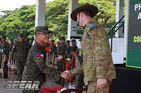 Philippine Army's 9th Infantry Division Chief of Staff Col. Ivan V. San Jose firmly shakes hands with an Australian Army officer as a gesture of a stronger partnership during the opening ceremony of Exercise Kasangga 2024-2 at Camp Elias Angeles, San Jose, Pili, Camarines Sur on October 14, 2024. (Photo courtesy of 9ID Public Affairs Office )