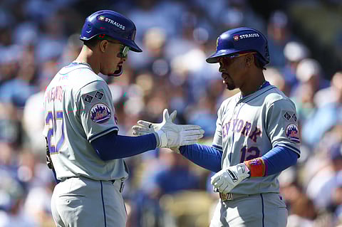 Mark Vientos and Francisco Lindor celebrate after leading the New York Mets to a 7-3 win over the Los Angeles Dodgers in Game 2 of their MLB playoff series.