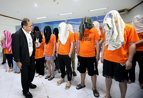 National Bureau of Investigation director Jaime Santiago presents to the media the 17 foreign nationals who were apprehended following an operation conducted by agents against cyber scams in Makati City on Tuesday.