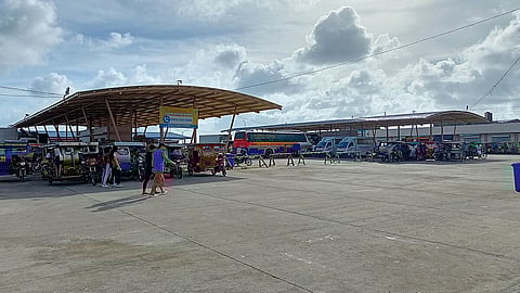 Motorized cycle rickshaws, buses and other passenger and non-passenger vehicles are parked in the Guiuan Integrated Transport Terminal, Guiuan, Eastern Samar, Philippines in April 2022.