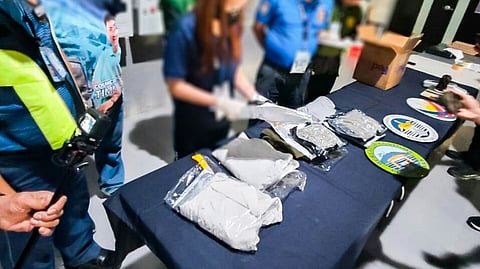 BUREAU of Customs officials examine the 1.48 grams of high-grade marijuana ‘kush’ discovered concealed in four garments at Clark port. The illegal shipment concealed in clothing to evade detection has an estimated street value of P1.572 million.