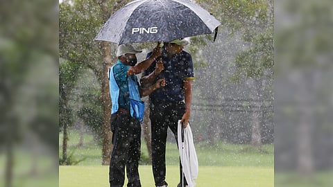 Keanu Jahns takes shelter from the rains.