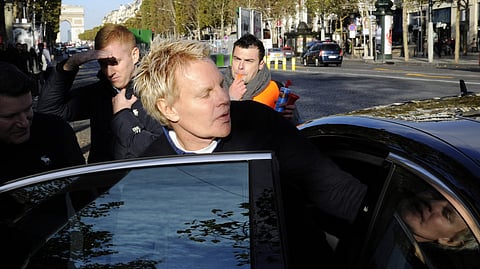 (FILES) US Mike Jeffries, CEO of US clothing retailer Abercrombie & Fitch, leaves the store on the Champs Elysees avenue in Paris on 27 October 2012, as some workers protest against their working conditions. Mike Jeffries, the former chief executive of the Abercrombie & Fitch clothing empire has been arrested and charged with the trafficking of male models for sex parties around the world, US prosecutors said on 22 October 2024.