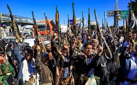 Houthi rebels holding their weapons.