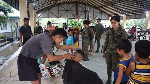 Members of the 91st Infantry ‘Sinagtala’ Battalion provide free haircuts to children of indigenous people at Barangay Diteki as part of the Philippine Army’s aim to assist beneficiaries in partnership with the Provincial Health Office Aurora and Barangay Diteki chairperson Gonzalo Carlos Jr.