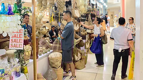 Staff of the Marinduque Tourism Office (left) prepares the products of the province during the Tatak Pinoy: OBRA MIMAROPA at the Glorietta 3 Activity Center in Makati City on Sunday. Other booths (above) in the trade fair feature diverse products.