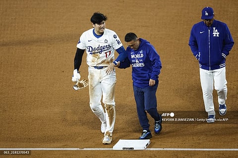 LOS ANGELES, CALIFORNIA - OCTOBER 26: Shohei Ohtani #17 of the Los Angeles Dodgers walks off the field after being injured while attempting to steal second base as they play against the New York Yankees in the seventh inning during Game Two of the 2024 World Series at Dodger Stadium on October 26, 2024 in Los Angeles, California. Kevork Djansezian/Getty Images/AFP