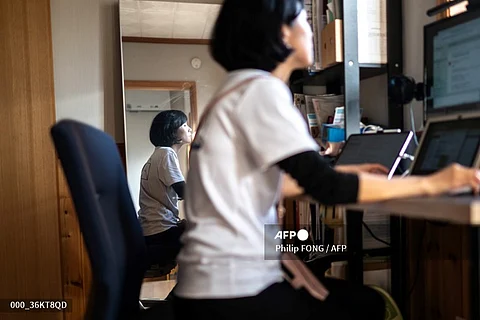 LOOK: This photo taken on October 22, 2024 shows Kaori Ishikawa, an assemblywoman in Hitachi city, working at her house in Hitachi city, Ibaraki Prefecture. To change, Japan needs more women in politics, says Ishikawa, 39, an assemblywoman and mother-of-two in Hitachi. Ishikawa was elected last year as the second-youngest of 24 local assembly members who are "mostly older men", like lawmakers in the national parliament. | Photo courtesy of Philip FONG / AFP