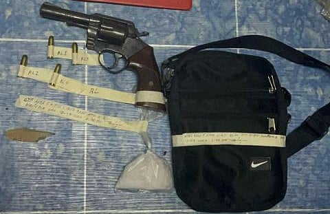 Wanted man yields gun, illegal drugs