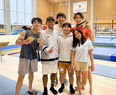 Karl Eldrew Yulo (third from left) and sister Elaiza Andriel Yulo (right) are visited by Japanese Olympic gold medalists Oka Shinnosuke (fifth from left) and Sugino Takaaki (left) at the Tokushukai Gymnastics Club during their training with coach Munehiro Kugimiya (back). Also shown is national junior coach Michael Sumabal.