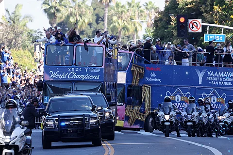 Fans celebrate as the Los Angeles Dodgers make their way in downtown Los Angeles in a victory parade after winning the World Series title.