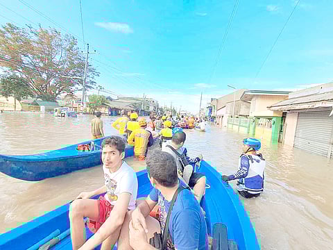 Rescuers from Manila City help flood victims in Naga City, Camarines Sur after the onslaught of severe tropical storm ‘Kristine’ on 27 October.