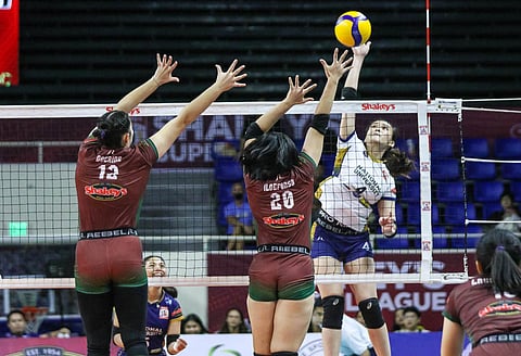 BELLA Belen of the NU Lady Bulldogs attacks the defense of Sam Ildefonso of the UP Fighting Maroons during their Shakey’s Super League Collegiate Pre-season Championship game late Sunday.