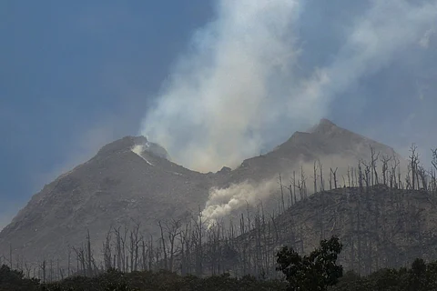 Smoke billows from Mount Lewotobi Laki-Laki as seen from Klatanlo village, in East Flores Regency, East Nusa Tenggara, on Nov. 4, 2024, after it erupted several times overnight. At least 10 people died after the volcano eruption, officials said on Nov. 4, raising the alert level to the highest of a four-tiered system.