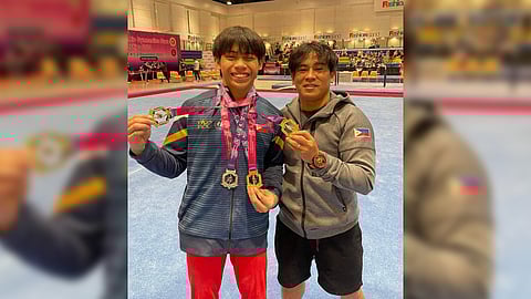 KARL Eldrew Yulo displays his medals following his successful participation in the 3rd JRC Artistic Gymnastics Stars Championships in Thailand. Also shown is his coach, Reyland Capellan.