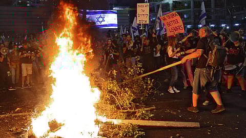 Israelis protestors set a fire and block a road in Tel Aviv after Yoav Gallant's sacking as defence minister