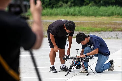 This picture taken on October 16, 2024 shows a student operating a multirotor drone during the Second National Defense Application of the unmanned aerial vehicle (UAV) Challenge in Chiayi.