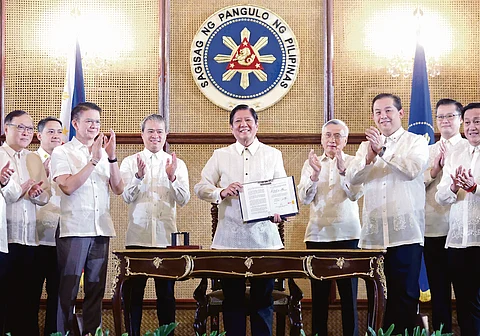 For an empowered workforce President Ferdinand Marcos Jr. beams as he shows a copy of Republic Act 12063, or the Enterprise-Based Education and Training Framework Act, he signed in Malacañang Palace on Thursday in the presence of lawmakers and select government officials. The law is aimed to expand training opportunities for the Filipino workforce.