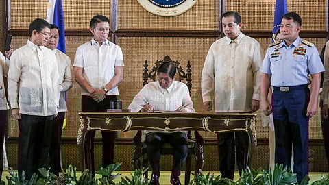 PRESIDENT Ferdinand R. Marcos Jr. signs Republic Act 12064 or the Philippine Maritime Zones Act and RA 12065, also known as the Philippine Archipelagic Sea Lanes Act into laws in a ceremony at Malacañan Palace yesterday.