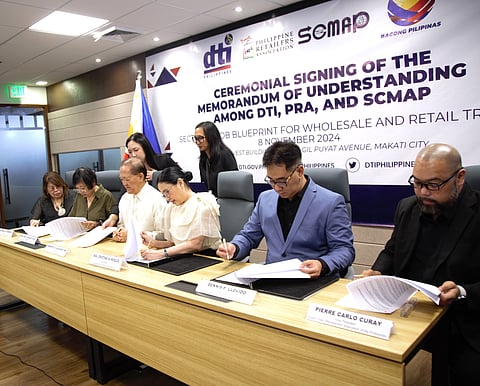 At the signing of the memorandum of understanding between the Department of Trade and Industry and the Philippine Retailers Association and Supply Chain Management Association of the Philippines are (seated, from left) Philippine Retailers Association official Alegria Limjoco; Trade Undersecretary Mary Jean Pacheco; PRA president Roberto Claudio; Trade Secretary Maria Cristina Aldeguer-Roque; Supply Chain Management Association of the Philippines president Dennis Llovido; and SCMAP past president Pierre Carlo Curay. The MoU is meant to policies and regulatory challenges that impact wholesale and retail operations and the entire supply chain.