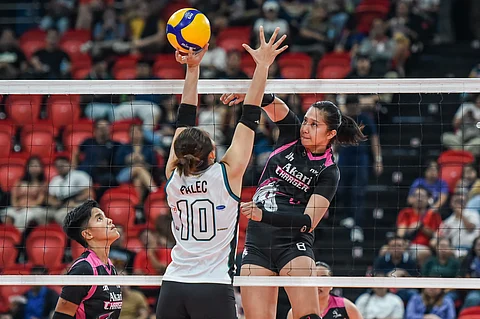 Ezra Madrigal of Akari challenges the single coverage defense put up by Shannen Palec of Galeries Tower during their PVL All-Filipino Conference game. The Chargers won, 28-30, 25-15, 25-16, 25-23.