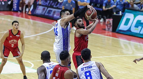 TNT guard RR Pogoy blocks Barangay Ginebra top rookie RJ Abarrientos’
jumper during the Tropang Giga’s 95-85 Finals Game 6 victory to capture
the PBA Governors’ Cup crown.