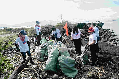 Volunteers collect trash along the coastline of San Pascual, Batangas during the annual Chevron Coastal Cleanup.