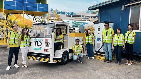 A Step Forward to Sustainability: Photo shows Cebu Pacific personnel conducting an electric vehicle baggage tractor trial run at NAIA.