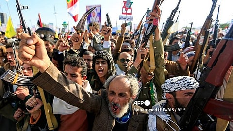 Yemenis brandish rifles and chant slogans during an anti-Israel demonstration in solidarity with Gaza and Lebanon in the Huthi-controlled capital Sanaa on 15 November 2024.