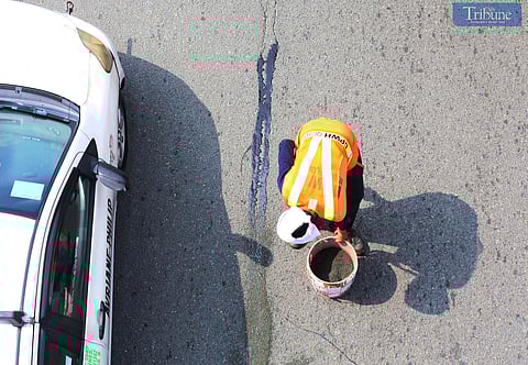 On Friday, 15 November, 2024, Department of Public Works and Highways (DPWH) workers repaired asphalt damage caused by rain at Philcoa along Commonwealth Avenue in Quezon City. Such maintenance is crucial to ensure road safety and prevent further deterioration.