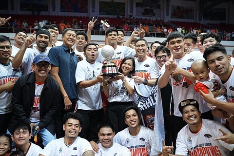 Quezon Province Gov. Helen Tan and her son, Cong. Mike Tan, lift the trophy after the Huskers completed a thrilling 65-60 win over the Batangas City Tanduay Rum Masters to rule the South Division of the MPBL Sixth Season late Thursday.