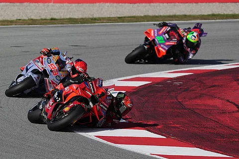Ducati Italian rider Francesco Bagnaia rides ahead of Ducati Spanish rider Marc Marquez and Ducati Italian rider Franco Morbidelli during the Moto GP qualifying session for the Solidarity Grand Prix of Barcelona at the Circuit de Catalunya on 16 November, 2024 in Montmelo on the outskirts of Barcelona.