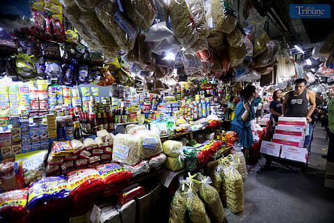 Personnel assist customers at a mini-grocery selling mostly Noche Buena items at Commonwealth Market in Quezon City on Friday, 22 November 2024. The Department of Trade and Industry (DTI) has released a price guide for common Noche Buena items, effective until 31 December 2024, to ensure reasonably priced products for the holiday season.