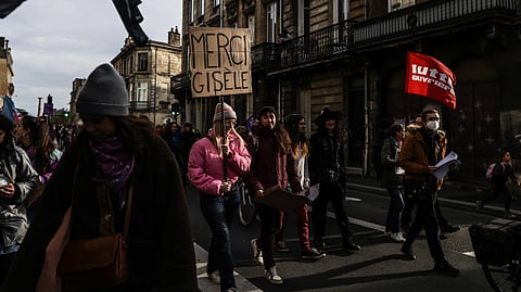 A protester holds a placard reading "Thank you Gisele" (referring to Gisele Pelicot) during a demonstration to condemn sexist and sexual violence against women and marking International Day for the elimination of violence against women in Bordeaux, southwestern France, on 23 November 2024.