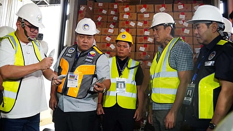 AGRICULTURE Secretary Francisco Tiu Laurel (leftmost) and Bureau of Customs Bienvenido Rubio (second from left) preside over the release of the seized mackerels.