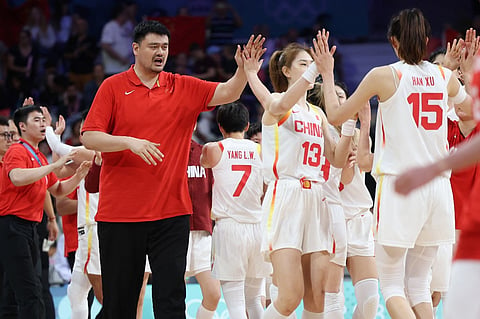 Chinese players and Former Chinese player Yao Ming (L) celebrate at the end of the women's preliminary round group A basketball match between China and Puerto Rico during the Paris 2024 Olympic Games at the Pierre-Mauroy stadium in Villeneuve-d'Ascq, northern France, on 3 August, 2024.