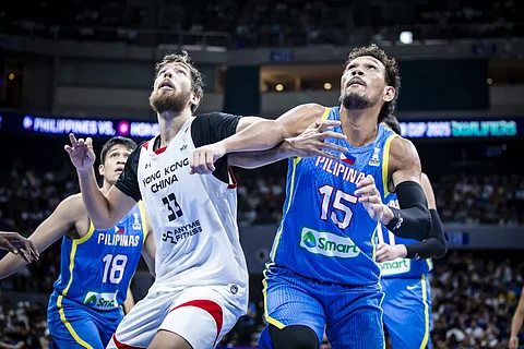 LOOK: June Mar Fajardo of the Philippines jockeys for position against Duncan Reid of Hong Kong during their game in the second window of the FIBA Asia Cup Qualifiers. The Filipinos won, 93-54. | FIBA PHOTO