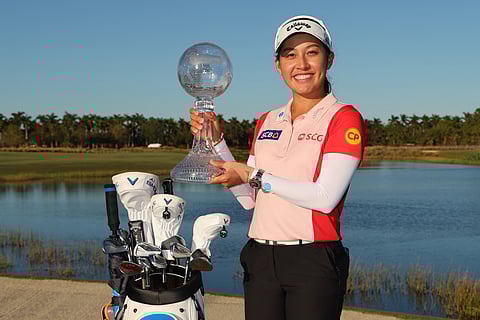 JEENO Thitikul raises the trophy after winning the LPGA’s season-ending Tour Championship.