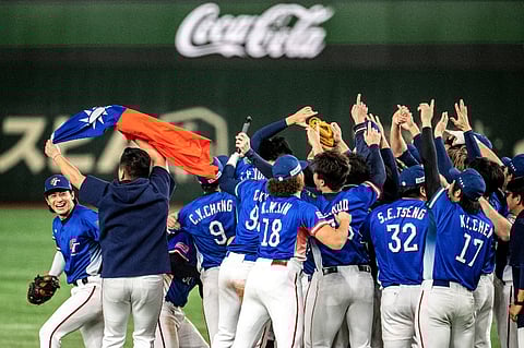 Team Taiwan celebrates with their national flag after their victory against Japan at the final match during the WBSC Premier12 2024 baseball tournament in Tokyo Dome, in Tokyo on 24 November, 2024.