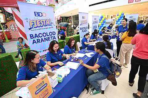 BDO personnel gamely facilitate the registration process and address queries from clients on various BDO products and services during the BDO Fiesta held in SM City Bacolod.