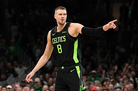 BOSTON, MASSACHUSETTS - NOVEMBER 25: Kristaps Porzingis #8 of the Boston Celtics reacts after making a three-point basket against the LA Clippers during the first quarter at the TD Garden on November 25, 2024 in Boston, Massachusetts.