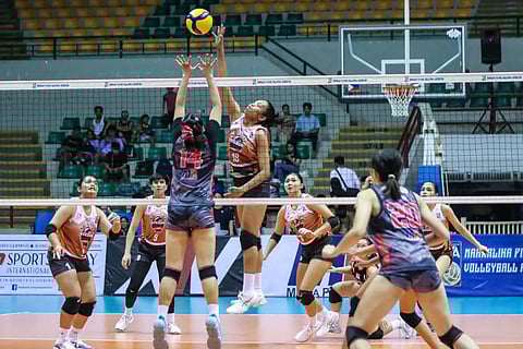 Cristy Ondangan of Quezon soars for an attack over the defense of Jen Villegas of Biñan during Game 1 of their MPVA best-of-three title series late Monday at the Alonte Sports Arena in Biñan City.