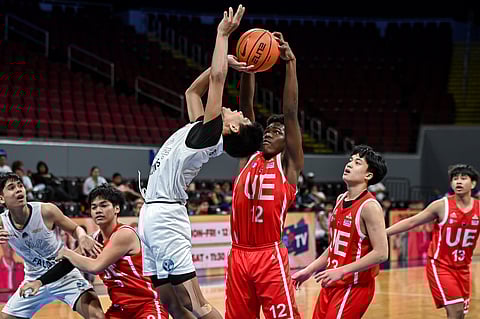 Goodluck Okebata of UE blocks the undergoal stab of Prince Banate of Adamson during their UAAP Season 87 junior high school game on Tuesday. The Junior Warriors prevailed, 100-58.