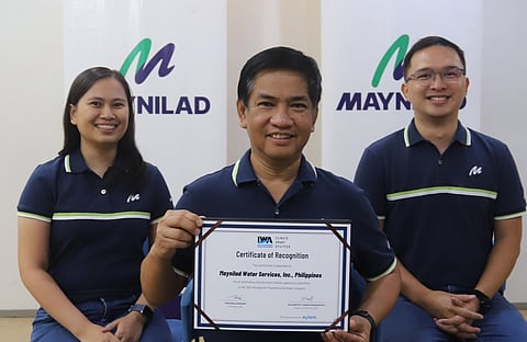 Maynilad Chief Sustainability Officer Atty. Roel S. Espiritu (center) holds the certificate of recognition given to Maynilad by the International Water Association (IWA) for being one of 28 “climate smart” utilities worldwide cited during the 2024 IWA Climate Smart Utilities Recognition. With Espiritu are (from left) Sustainability Assistant Manager Apple Joy Albero and Sustainability Head John Emmanuel Martinez. Maynilad was recognized for its for its innovative strategies to mitigate and adapt to the impacts of climate change.