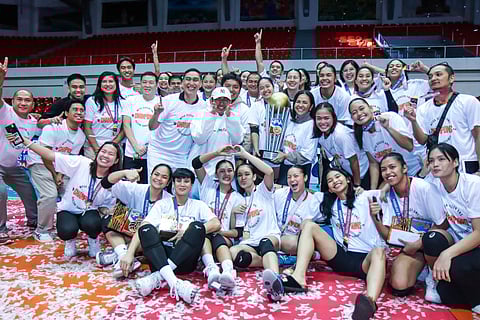 Quezon Gov. Helen Tan (middle) lifts the trophy after the Tangerines completed a sweep of Biñan in the 2024 Maharlika Pilipinas Volleyball Association best-of-three finals series late Wednesday at the Quezon Convention Center.