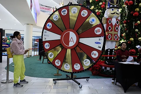 EAST RUTHERFORD, NEW JERSEY - 29 NOVEMBER: A woman take part in a roulette prices game as she visits the American Dream Mall During Black Friday sales in East Rutherford City. Black Friday, is the sales event that is considered the unofficial kickoff of the holiday shopping season and one of the busiest days of the year for retail foot traffic in the U.S.